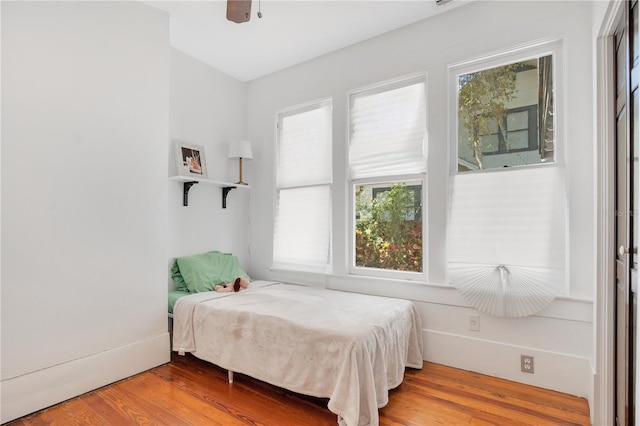 bedroom with a ceiling fan and wood finished floors