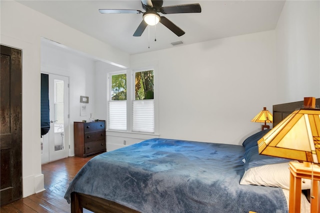 bedroom featuring visible vents, a ceiling fan, and hardwood / wood-style flooring