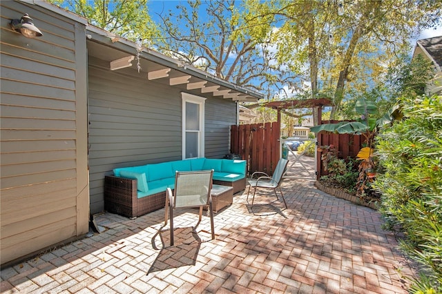 view of patio / terrace with outdoor lounge area and fence