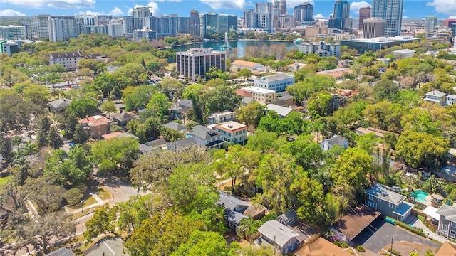 drone / aerial view featuring a city view and a water view