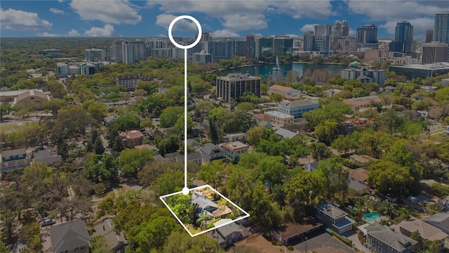 drone / aerial view featuring a view of city and a water view