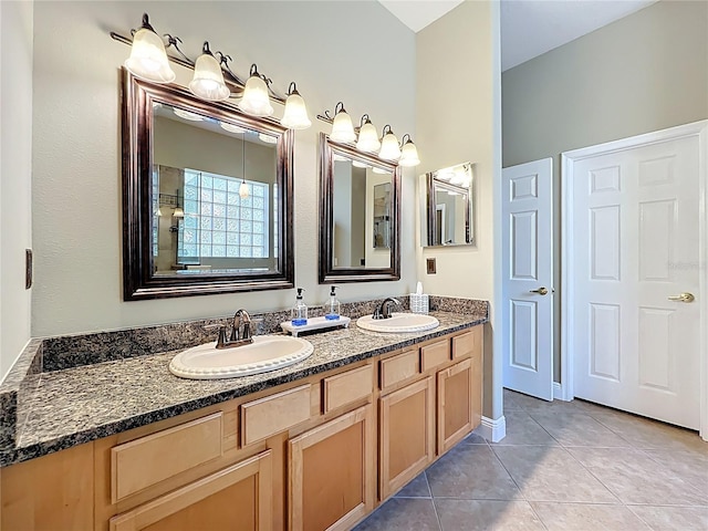 bathroom with tile patterned flooring, double vanity, and a sink