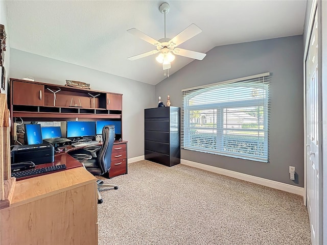 office space with lofted ceiling, a ceiling fan, light colored carpet, and baseboards