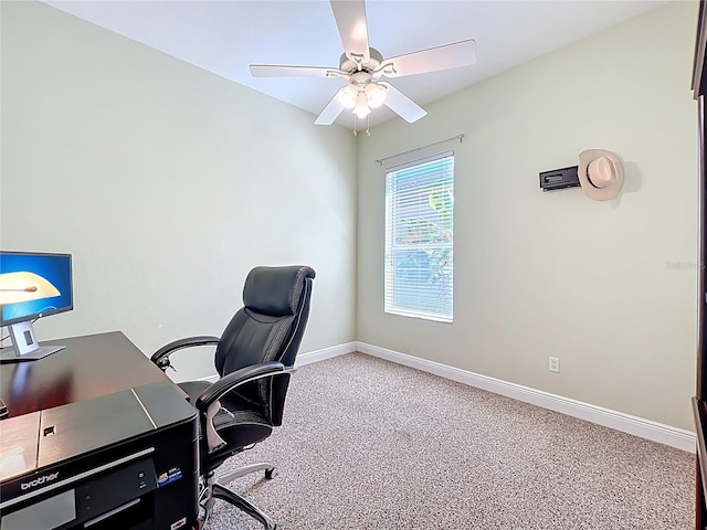 carpeted home office with a ceiling fan and baseboards