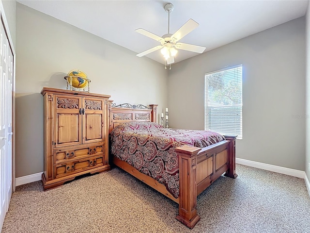 bedroom featuring baseboards, light carpet, and ceiling fan