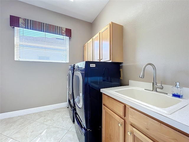 laundry room with a sink, cabinet space, separate washer and dryer, light tile patterned floors, and baseboards