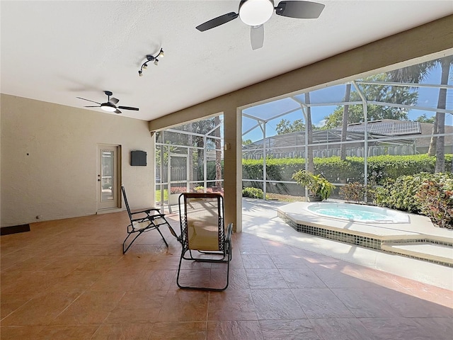 sunroom featuring ceiling fan