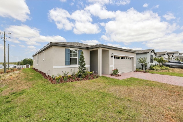 800 Griffon Ave, Lake Alfred, FL 33850 - view of front of house with stucco siding, decorative driveway, a garage, and a front lawn
