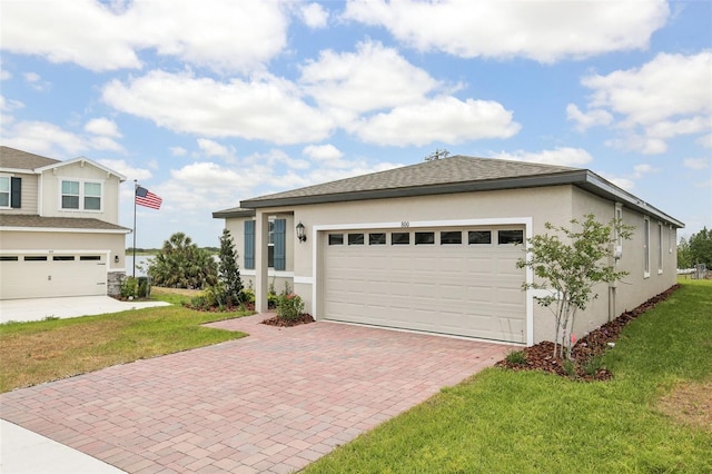 800 Griffon Ave, Lake Alfred, FL 33850 - view of front facade featuring stucco siding, decorative driveway, and a front lawn
