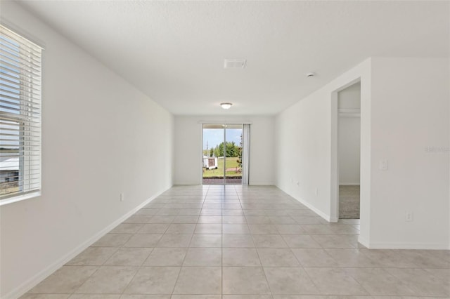 800 Griffon Ave, Lake Alfred, FL 33850 - empty room featuring light tile patterned flooring and baseboards