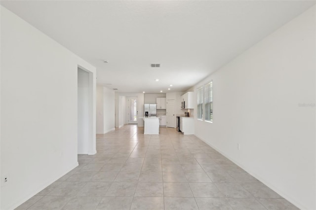800 Griffon Ave, Lake Alfred, FL 33850 - unfurnished living room with light tile patterned floors, baseboards, and recessed lighting