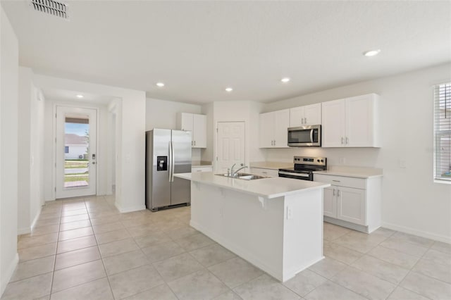 800 Griffon Ave, Lake Alfred, FL 33850 - kitchen with stainless steel appliances, a sink, light countertops, white cabinetry, and recessed lighting