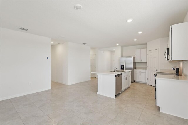 800 Griffon Ave, Lake Alfred, FL 33850 - kitchen with appliances with stainless steel finishes, recessed lighting, a center island with sink, open floor plan, and light countertops