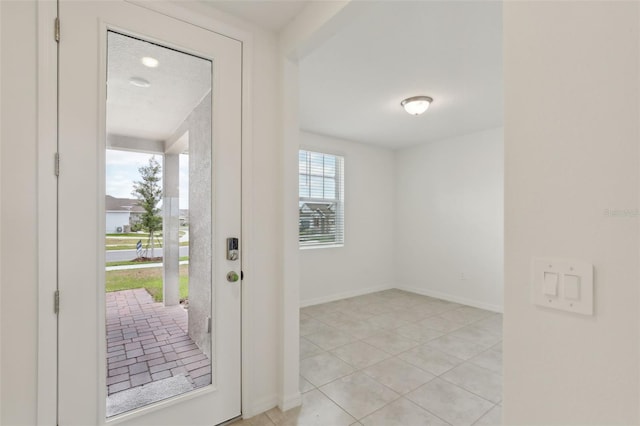 800 Griffon Ave, Lake Alfred, FL 33850 - doorway to outside with baseboards and light tile patterned flooring