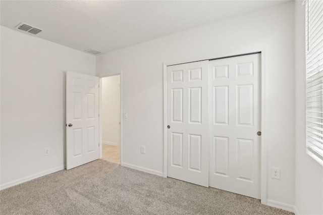 800 Griffon Ave, Lake Alfred, FL 33850 - unfurnished bedroom with carpet, a closet, and baseboards