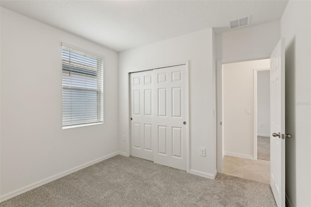 800 Griffon Ave, Lake Alfred, FL 33850 - unfurnished bedroom with carpet, baseboards, and a closet