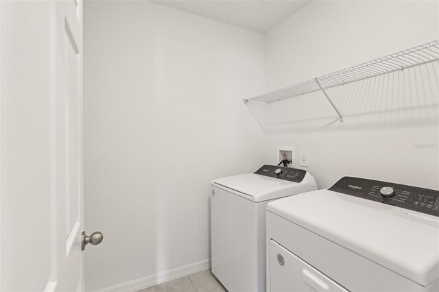 800 Griffon Ave, Lake Alfred, FL 33850 - laundry area with washer and dryer, baseboards, and light tile patterned floors