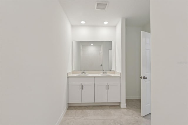 800 Griffon Ave, Lake Alfred, FL 33850 - full bathroom featuring double vanity, a tile shower, tile patterned floors, and baseboards