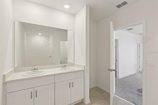 800 Griffon Ave, Lake Alfred, FL 33850 - bathroom with double vanity, a shower, tile patterned floors, baseboards, and recessed lighting