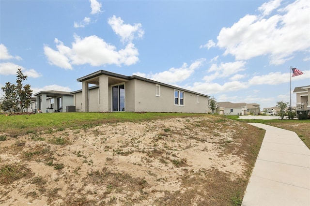 800 Griffon Ave, Lake Alfred, FL 33850 - view of side of home with stucco siding, central air condition unit, and a residential view