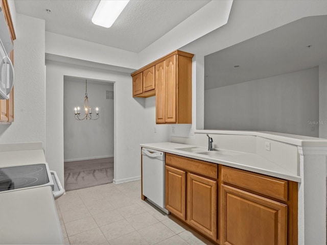 kitchen with dishwasher, light countertops, brown cabinets, and a sink