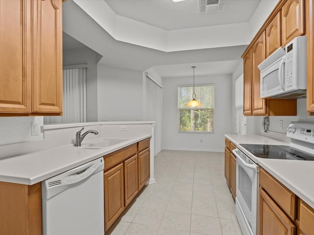 kitchen featuring visible vents, light countertops, light tile patterned floors, white appliances, and a sink