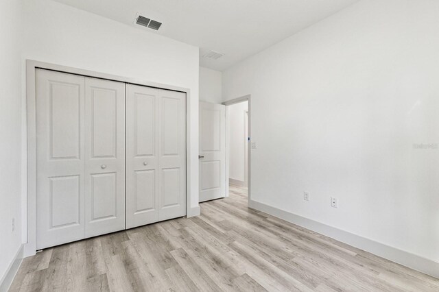 15369 SW 60th Cir, Ocala, FL 34473 - unfurnished bedroom with light wood-style floors, a closet, and baseboards