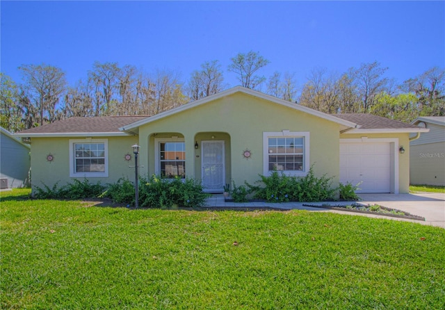 ranch-style house with stucco siding, a garage, concrete driveway, and a front yard