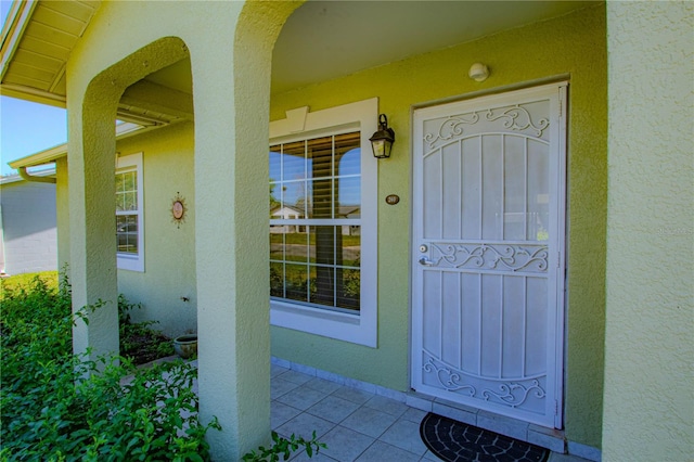 entrance to property featuring stucco siding