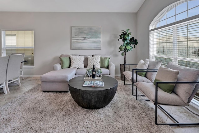 living room with baseboards and tile patterned flooring