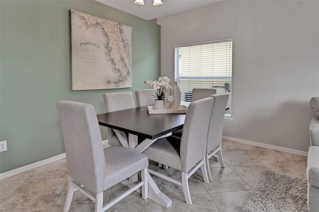 dining space with light tile patterned floors and baseboards