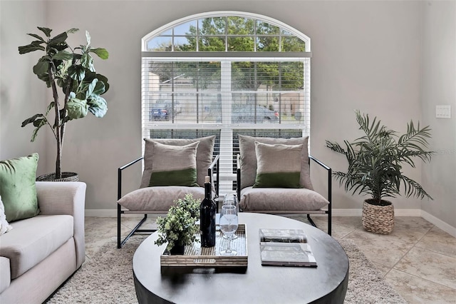 tiled living room featuring baseboards