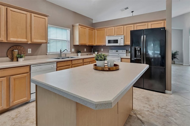 kitchen featuring white appliances, light brown cabinets, visible vents, a sink, and light countertops