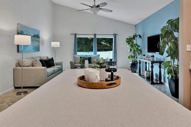 tiled living room featuring a ceiling fan and lofted ceiling