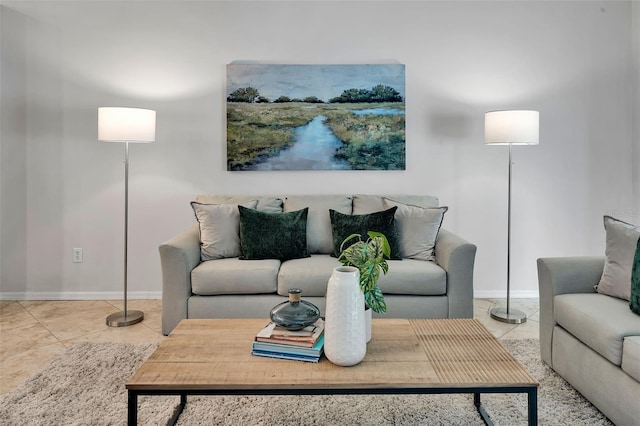 living room featuring tile patterned floors and baseboards