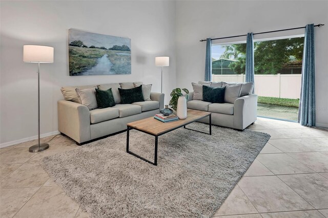 living room with baseboards and tile patterned flooring