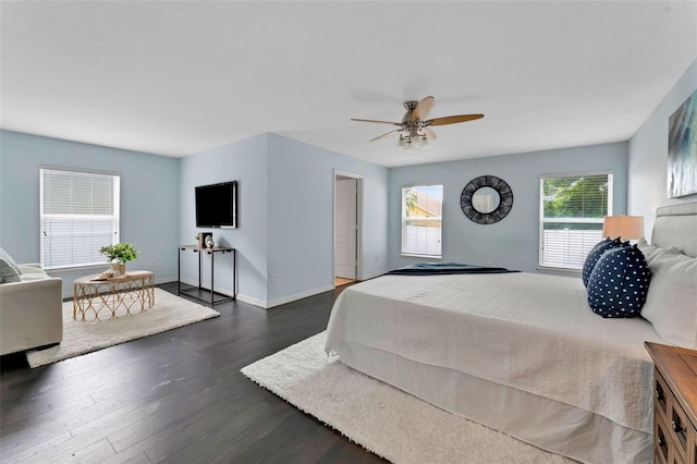 bedroom featuring a ceiling fan, baseboards, and dark wood-style flooring