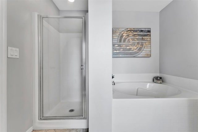 bathroom featuring a garden tub and a stall shower