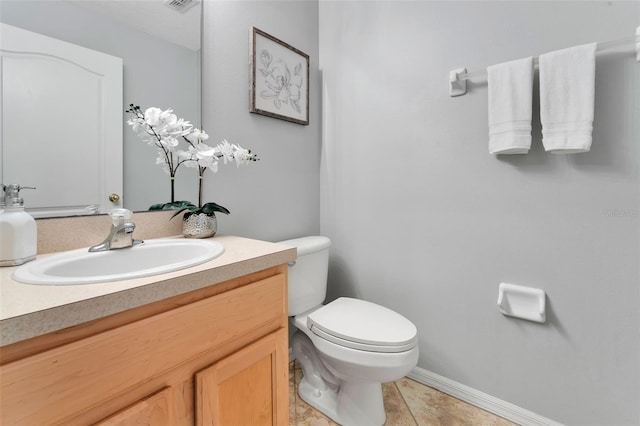 half bath featuring tile patterned floors, visible vents, toilet, and vanity