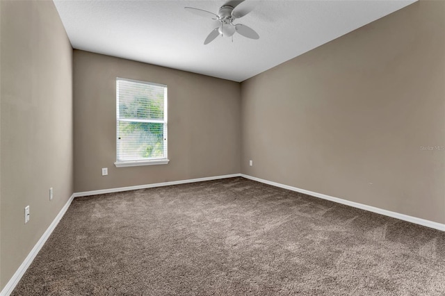 carpeted spare room with a textured ceiling, a ceiling fan, and baseboards