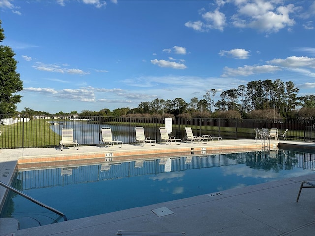 community pool featuring a patio and fence