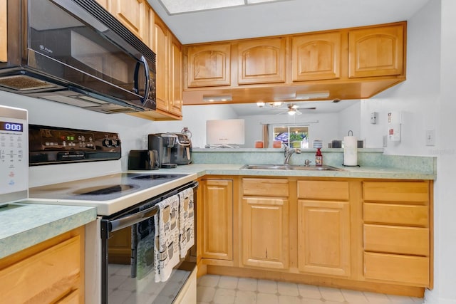 kitchen with black microwave, light countertops, range with electric stovetop, a ceiling fan, and a sink