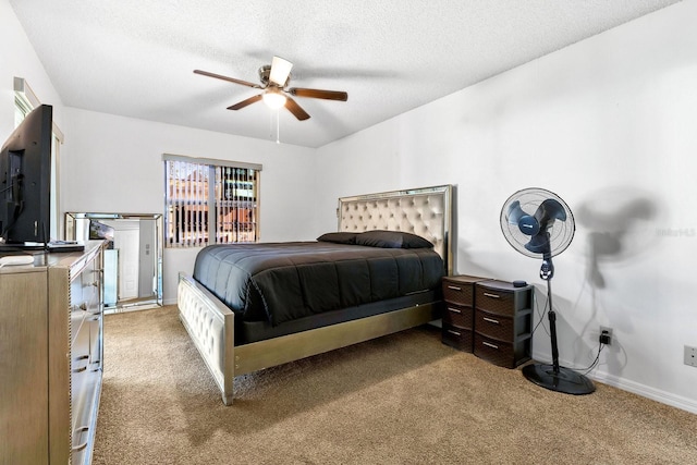 carpeted bedroom with baseboards, a textured ceiling, and a ceiling fan