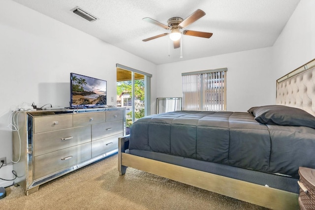 bedroom featuring visible vents, light carpet, access to outside, a textured ceiling, and ceiling fan