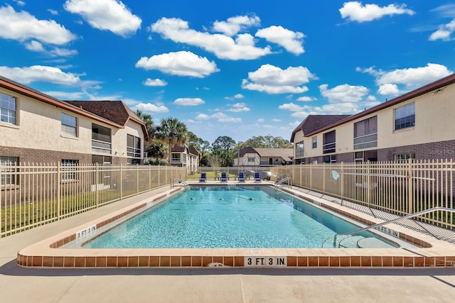 pool featuring a residential view and fence