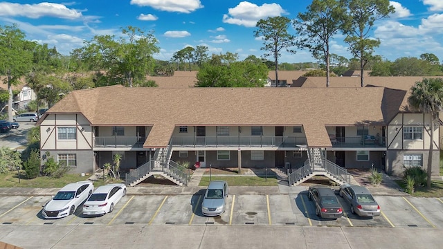 view of building exterior with uncovered parking