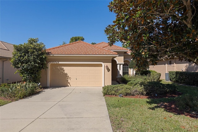 mediterranean / spanish-style house featuring a tiled roof, stucco siding, an attached garage, and driveway