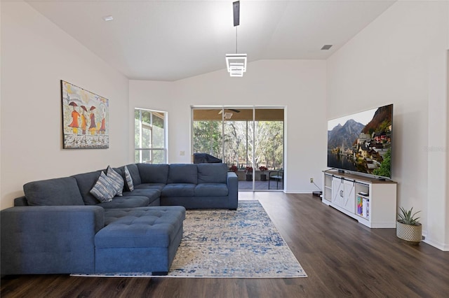 living area with baseboards, dark wood-type flooring, and vaulted ceiling