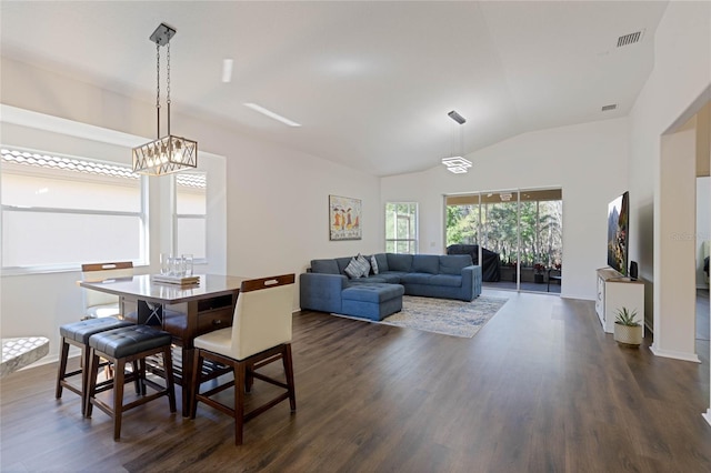 dining area featuring lofted ceiling, a notable chandelier, dark wood-style floors, and visible vents