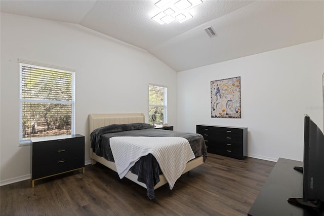 bedroom with vaulted ceiling, baseboards, visible vents, and dark wood-style flooring